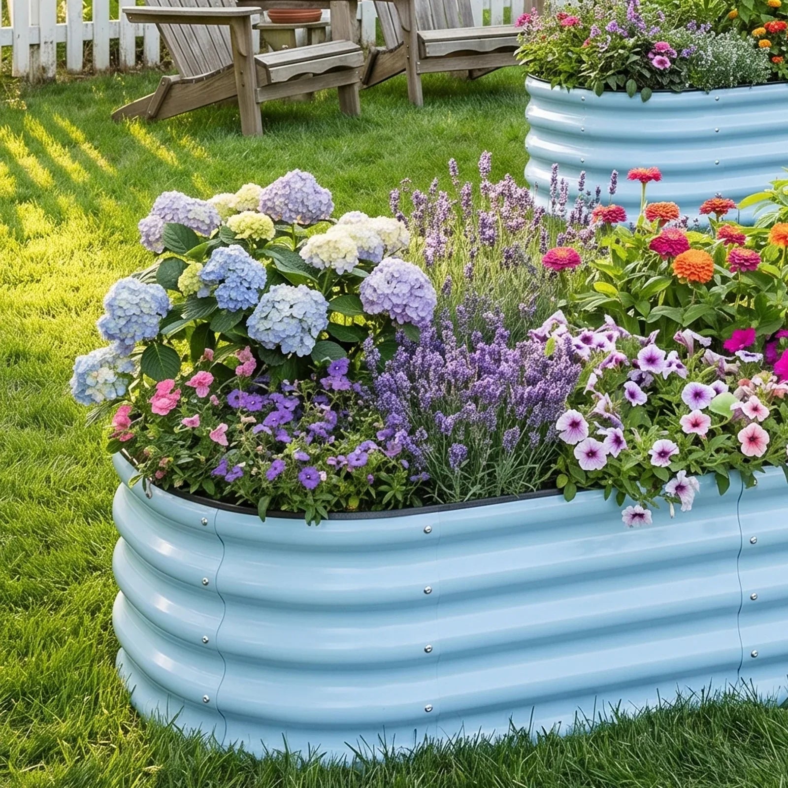 Light blue corrugated metal raised garden bed filled with colorful flowers in a sunny backyard